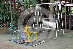 Metal swings on concrete floor