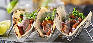 Metal taco holder with three mexican carne asada street-tacos