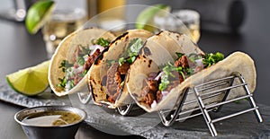 Metal taco holder with three mexican carne asada street-tacos photo