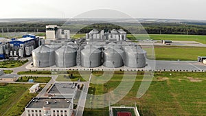 Metal tanks of the elevator. Grain drying complex in the open air. Commercial granaries. Steel warehouse for