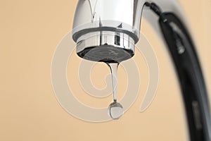 Metal tap on color background, closeup. Water saving concept