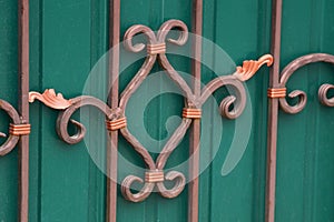 Metal texture of iron rods in a forged pattern on a green wall