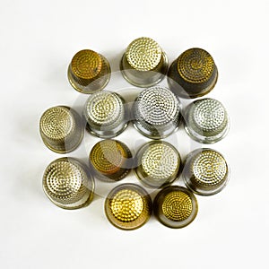 Metal thimbles on white background