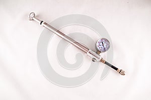 A metal tool with a white and black gauge on it