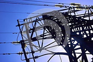 metal tower of a high voltage power line with insulators and wires