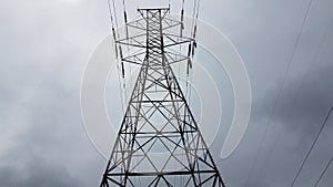 Metal tower with power or electrical lines and clouds