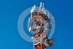 Metal tower with telecommunication antennas and parables photo