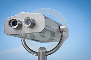 Metal tower viewer against blue sky, closeup. Mounted binoculars