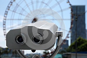 Metal tower viewer installed in city, closeup. Mounted binoculars