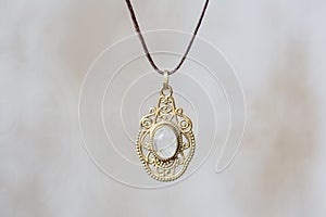 Metal tree shape pendant round mandala on neutral background