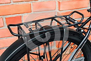 A metal trunk mounted on the back of a modern mtb bike. Close-up. Outdoors