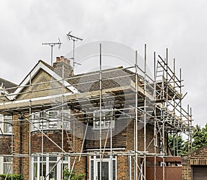 Metal tubular scaffolding around an urban semi detached house re photo