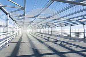 Metal tunnel grating with bright light at the end