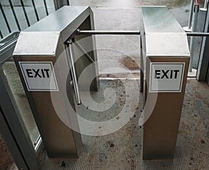 Metal Turnstile with inscription EXIT or urban Checkpoint close-up