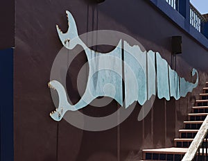 Metal two-headed sea monster sculpture alongside an outside stairway at the Hotel California in Todos Santos.