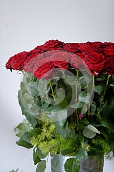 Metal vase of a bunch of red roses