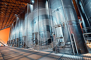 metal vats in which wine or beer is fermented at the factory at the winery. Concept of technologies and equipment for the