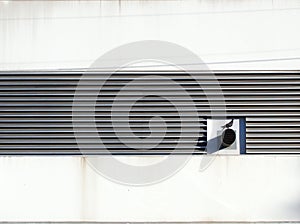Metal Ventilation Grills on a White Industrial Building