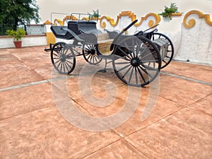 Metal wagon next to a cement wall