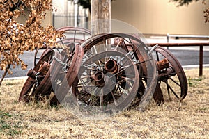 Metal wagon wheel rims for sale chained to a pole.
