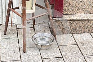 A metal water bowl stands outside, a street drinker for stray dogs and cats. photo