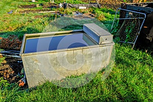 Metal water container at the allotments photo