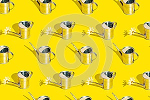 Metal watering can on bright yellow background. Garden can with sunshine and hard shadow. Summer, spring, garden pattern