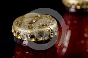 Metal wet cap on a dark glass bottle. A tasty drink closed with a cap.