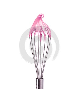 Metal whisk with pink cream isolated on black background. Clipping path.