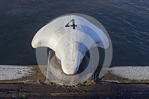 Metal white bollard from Rotterdam harbour with number four