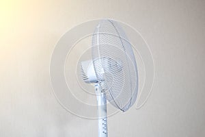 Metal white modern fan or vent..Closeup on working electric floor standing fan in the house. Sunny hot summer day. Ð¡ooling in the