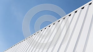 Metal white sheet for industrial building and construction on blue sky background. Roof sheet metal or corrugated roofs