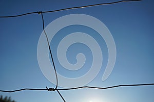 Metal wire fence, sky in background