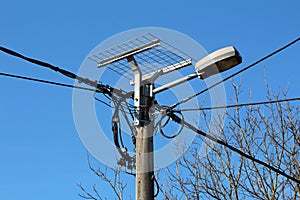 Metal wire mesh stand prepared for stork nest mounted with strong metal pipes on top of concrete utility pole