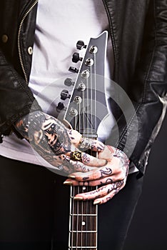 Metal, woman and guitar on black background for rock culture or grunge, edgy and goth fashion with closeup. Punk star