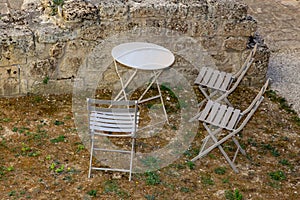 Metal wooden grey chair seat table gray in summer in street in ancient mediaeval village