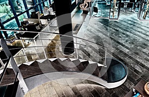 Metal and wooden spiral staircase in modern business office interior