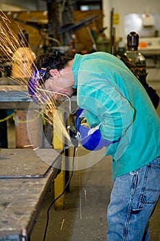 Metal Worker Using Grinder