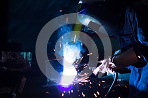 Metal workers use manual labor, Skilled welder, Factory workers making OT, The welder is welding the steel in the factory