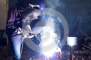 Metal workers use manual labor, Skilled welder, Factory workers making OT, The welder is welding the steel in the factory