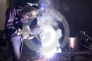 Metal workers use manual labor, Skilled welder, Factory workers making OT, The welder is welding the steel in the factory