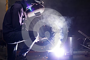 Metal workers use manual labor, Skilled welder, Factory workers making OT, The welder is welding the steel in the factory