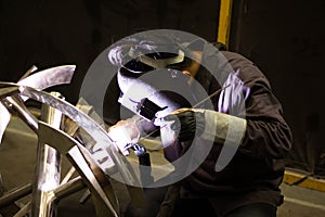 Metal workers use manual labor, Skilled welder, Factory workers making OT, The welder is welding the steel in the factory.