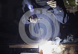 Metal workers use manual labor. Skilled welder. Factory workers making OT. Welder is welding the steel in the factory.