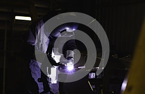 Metal workers use manual labor. Skilled welder. Factory workers making OT. Welder is welding the steel in the factory