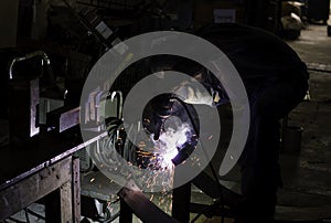 Metal workers use manual labor. Skilled welder. Factory workers making OT. Welder is welding the steel in the factory.