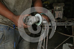 Metal works. Electric wheel grinding on steel structure in factory