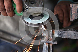 Metal works. Electric wheel grinding on steel structure in factory