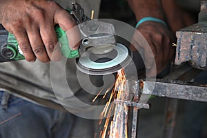 Metal works. Electric wheel grinding on steel structure in factory