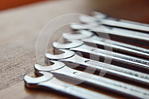 Metal wrenches on wooden background